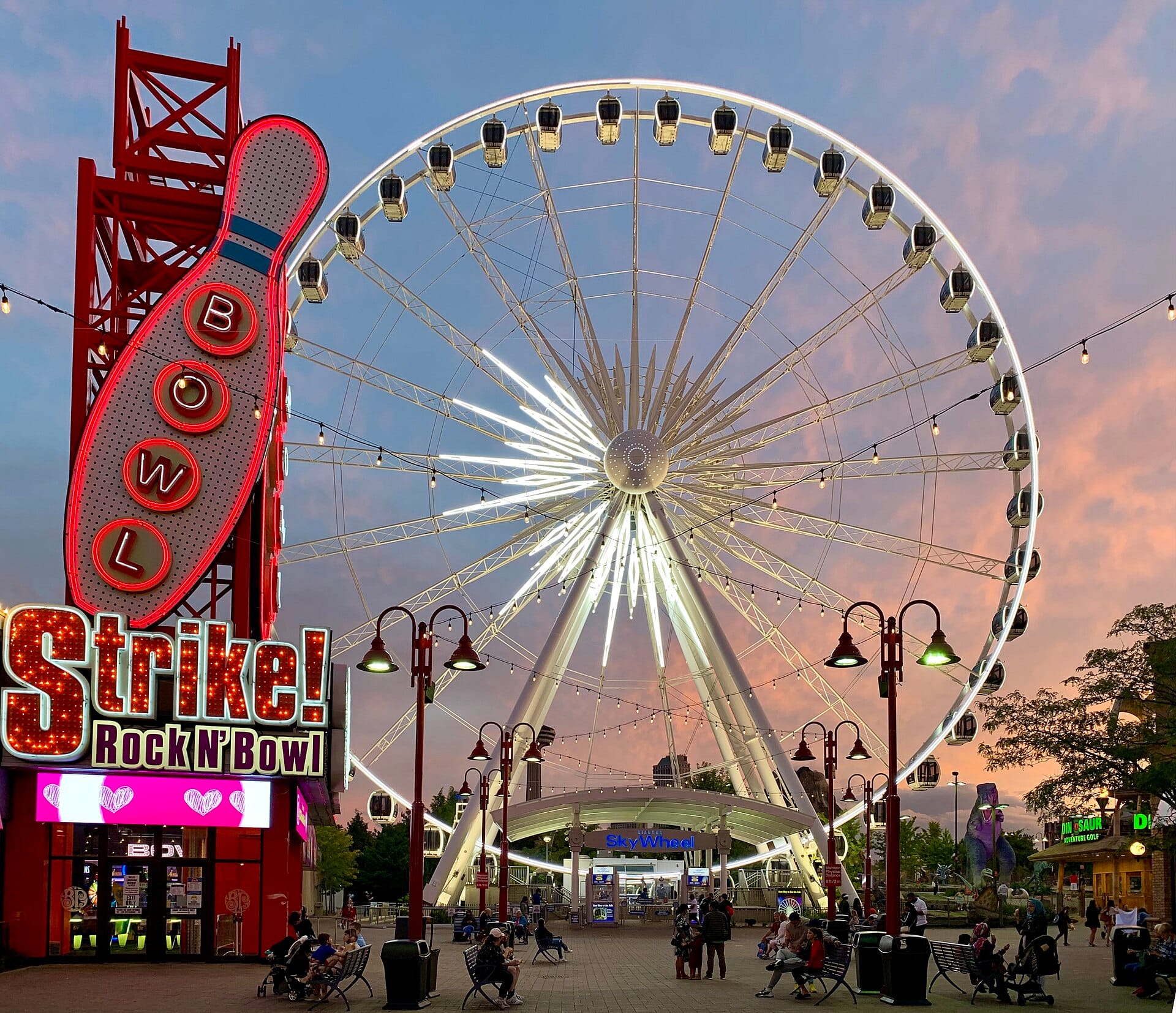 Niagara SkyWheel on Clifton Hill at dusk, beside the Strike bowling sign