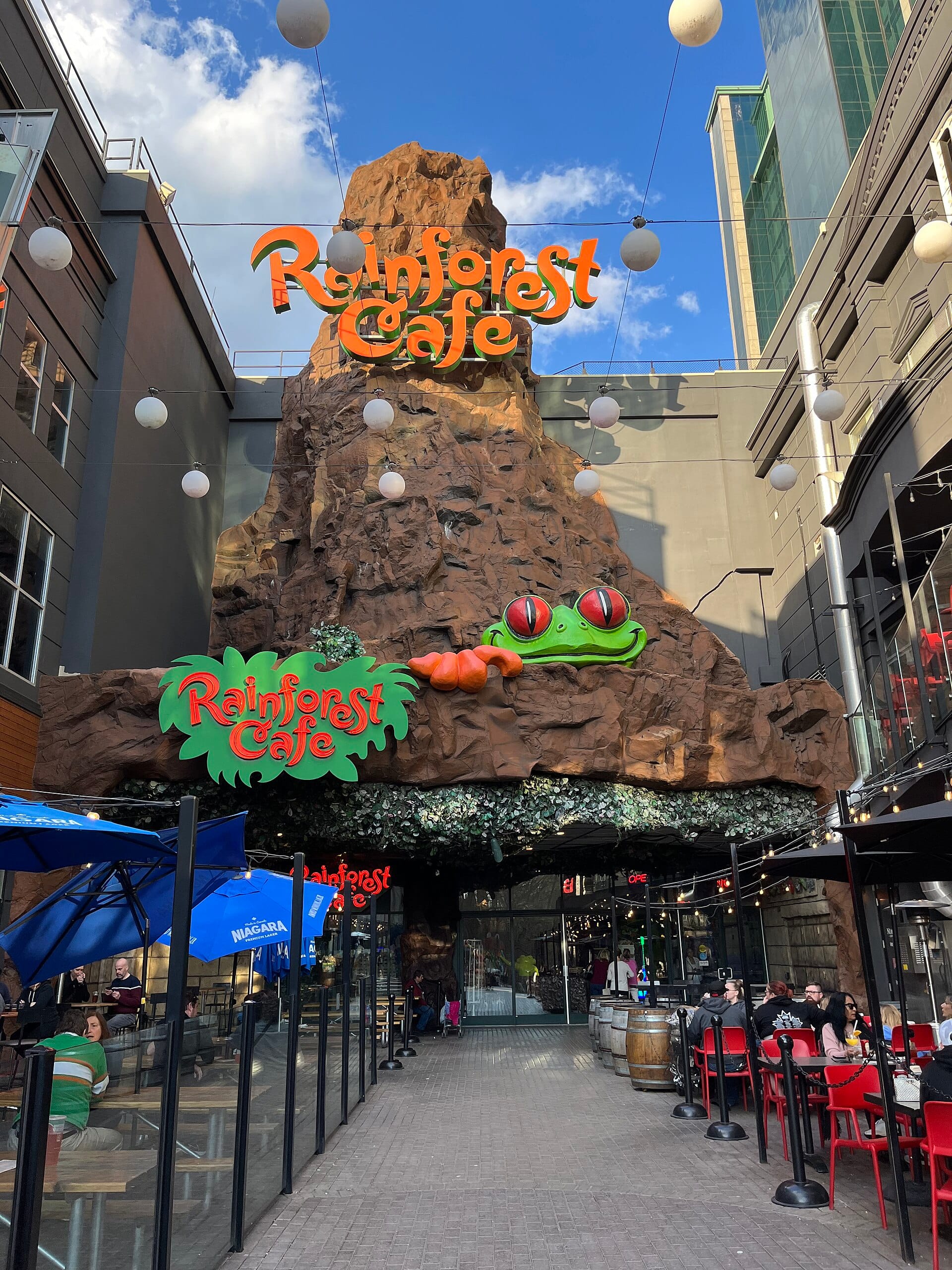 Rainforest Cafe entrance on Clifton Hill, with the volcano facade and frog sculpture